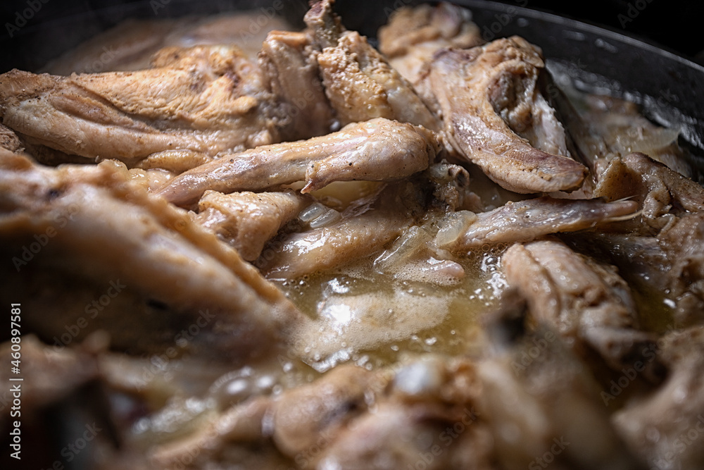 Chicken wings are cooked in their own juice in a pan Chicken wings are cooked in their own juice in a pan