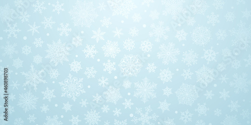 Christmas background of big and small complex snowflakes in light blue colors