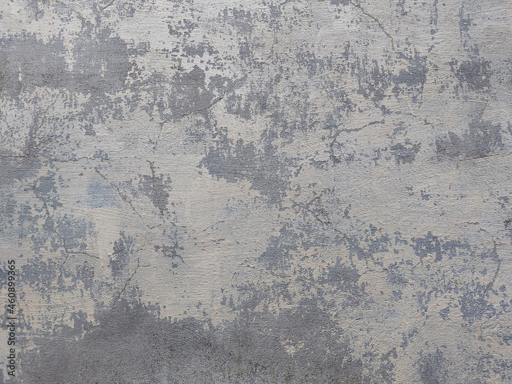 Old plastered wall, peeling light paint on cement, gray tone background