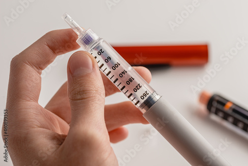 medicine, diabetes, glycemia, healthcare and people concept - close-ups of man's hands. Medical devices are used for self-injection to treat diabetes. World Diabetes Day and the concept of health care