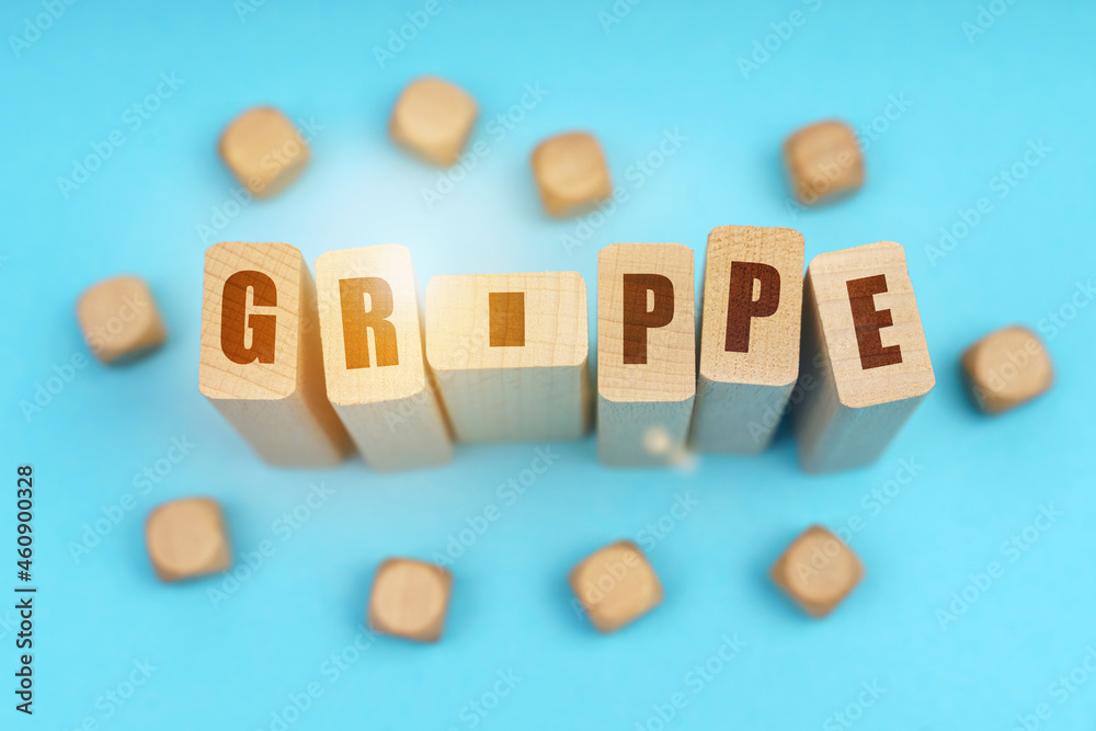 On a blue background, wooden cubes and Jenga with the inscription - Grippe On a blue background, wooden cubes and Jenga with the inscription - Grippe