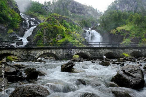 A beautiful landscape with a bridge by the Latefossen Waterfall and Espelandsfossen Waterfall in Norway photo