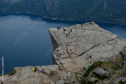 Preikestolen (Prekestolen, Pulpit Rock), Norway - circa July 2020: Famous tourist attraction near Stavanger. Preikestolen is steep cliff which rises above Lysefjord. Silhouettes of people on cliff.