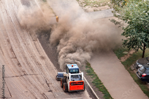 Aerial view dust, and stones road asphalt repairing working new road paving construction site. © svetlana