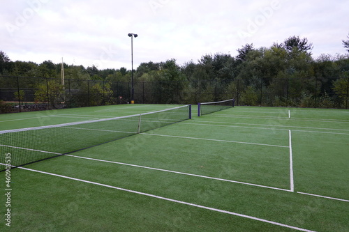 Tennis court with green turf background.