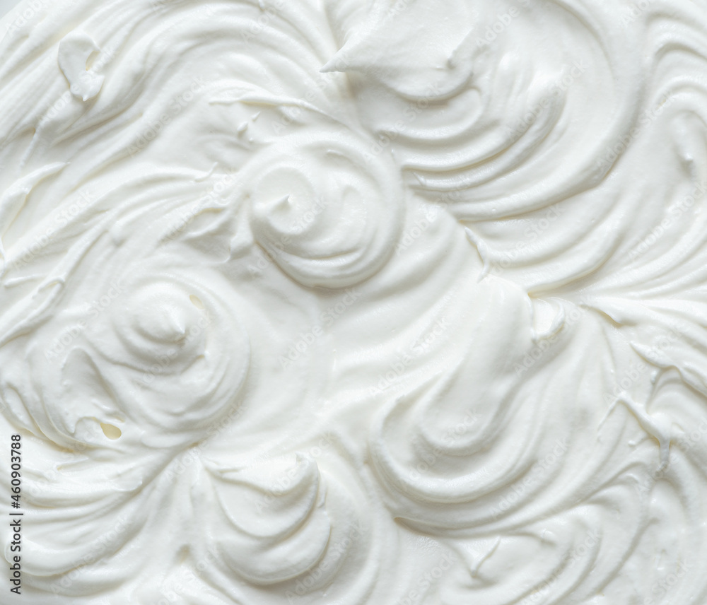 Fototapeta Creamy pics in yoghurt or cream surface. Top view.