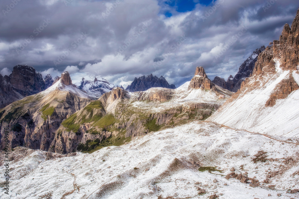 View of the rifugio Locatelli from the foot of Tre Cime di Lavaredo. A circular route in the Dolomites, Italy. Mountain scenery, first snow, national park.