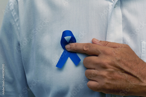 Blue november - man holding blue ribbon photo