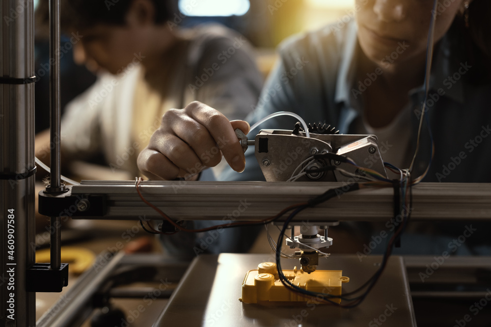 Smart students using a 3D printer Stock Photo | Adobe Stock