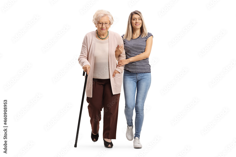 Full length portrait of a young woman helping an elderly woman and walking towards camera Full length portrait of a young woman helping an elderly woman and walking towards camera