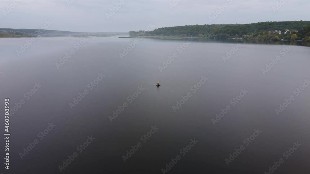 Aerial video flying over a pond and a rower in a boat Aerial video flying over a pond and a rower in a boat