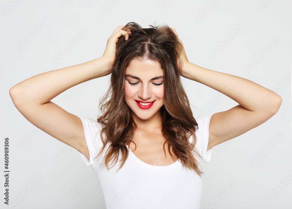 Beautiful happy girl touches her hair. Casual clothes. Beautiful happy girl touches her hair. Casual clothes.