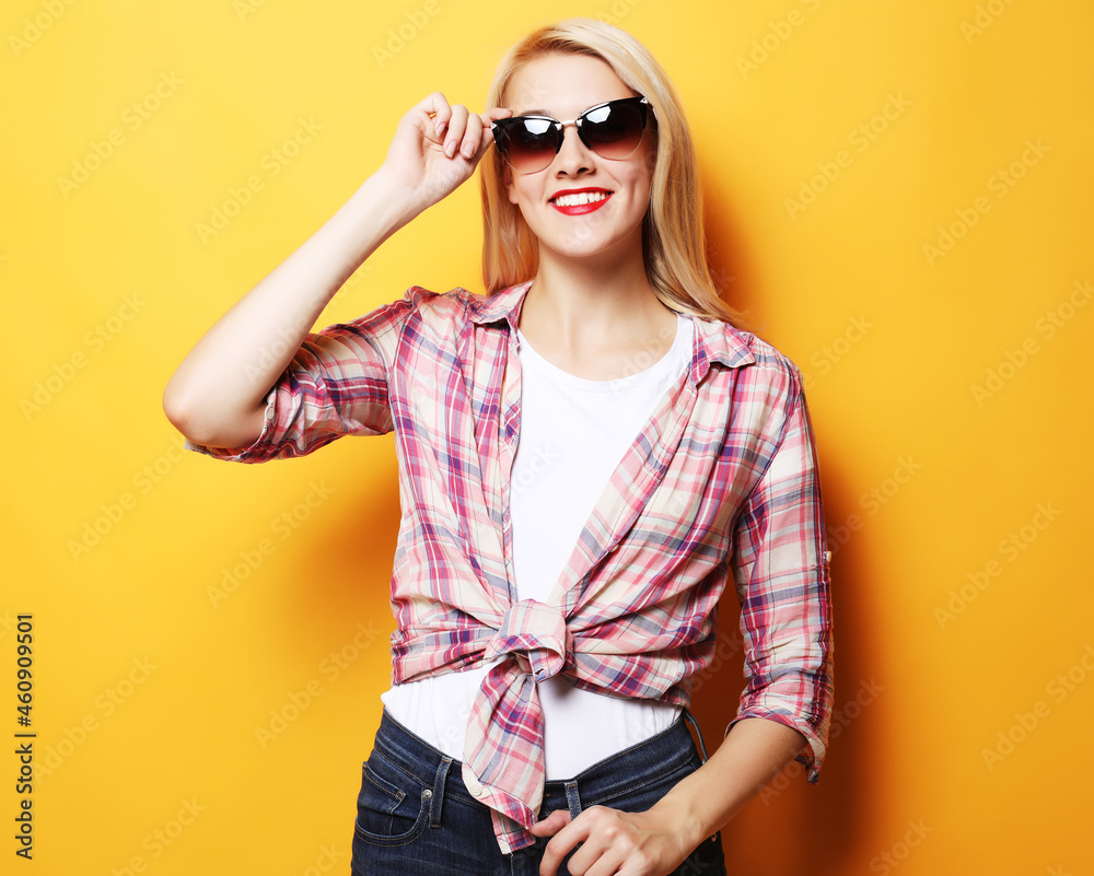Fototapeta premium Portrait of a young beautiful girl on a yellow background.