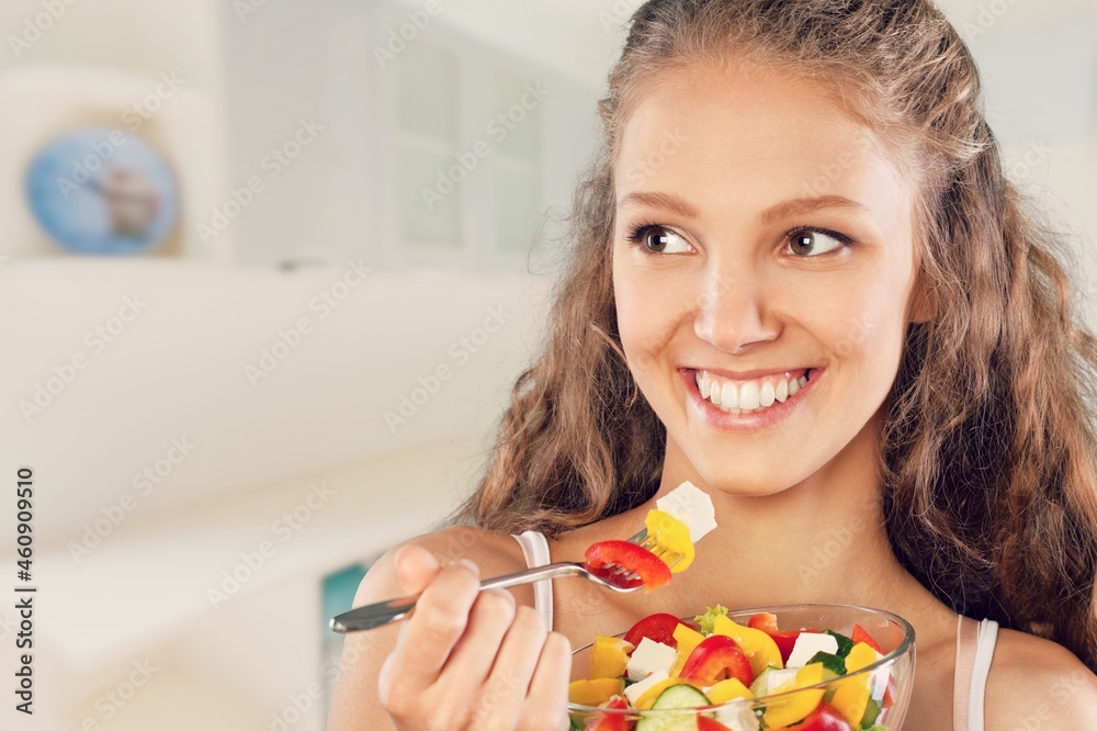 Portrait of attractive woman hold salad bowl and look at camera.