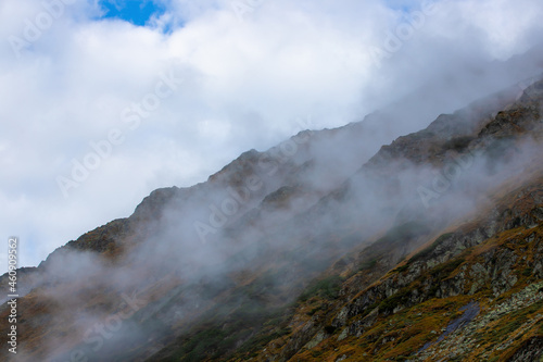 Fog clouds on a mountain slope