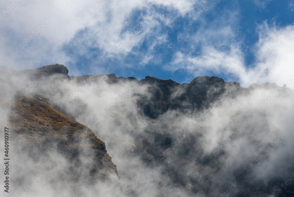 Landscape with clouds on mountain ridges