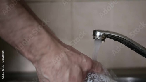 male hands washing dishes in the kitchen