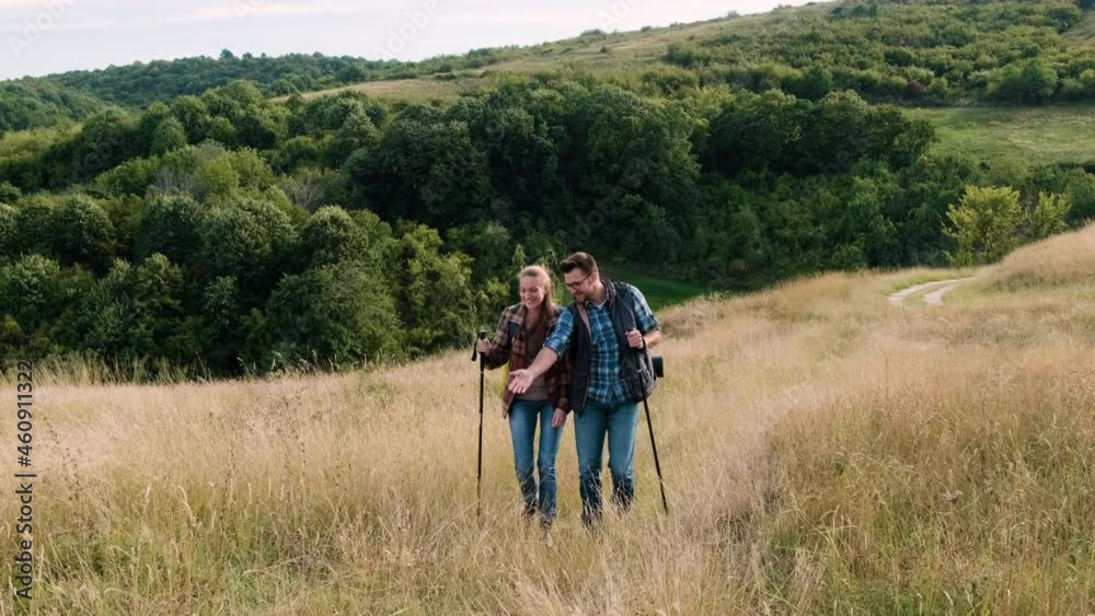 Couple with backpacks hiking together in nature on autumn day. Couple with backpacks hiking together in nature on autumn day.
