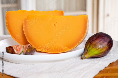 Cheese collection, French cheese mimolette made from cow milk served with fresh figs