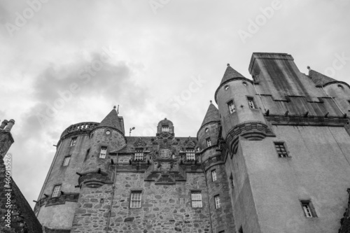 Grayscale low-angle shot of the famous historic Z-plan Castle Fraser against a cloudy sky photo