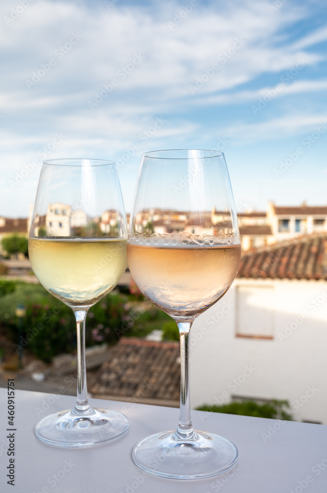 Summer on French Riviera Cote d'Azur, drinking cold rose and white wine from Cotes de Provence on outdoor terrase in Port Grimaud, Var, France Summer on French Riviera Cote d'Azur, drinking cold rose and white wine from Cotes de Provence on outdoor terrase in Port Grimaud, Var, France