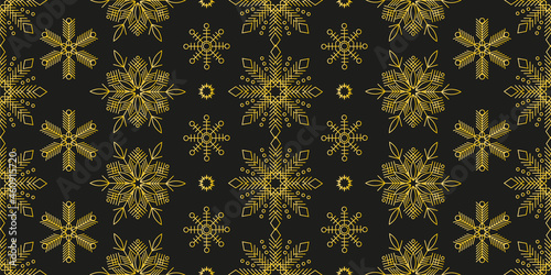 Seamless pattern with gold snowflakes on black for decoration of Christmas and New Year projects. Winter background for textiles, festive packaging, wallpaper.