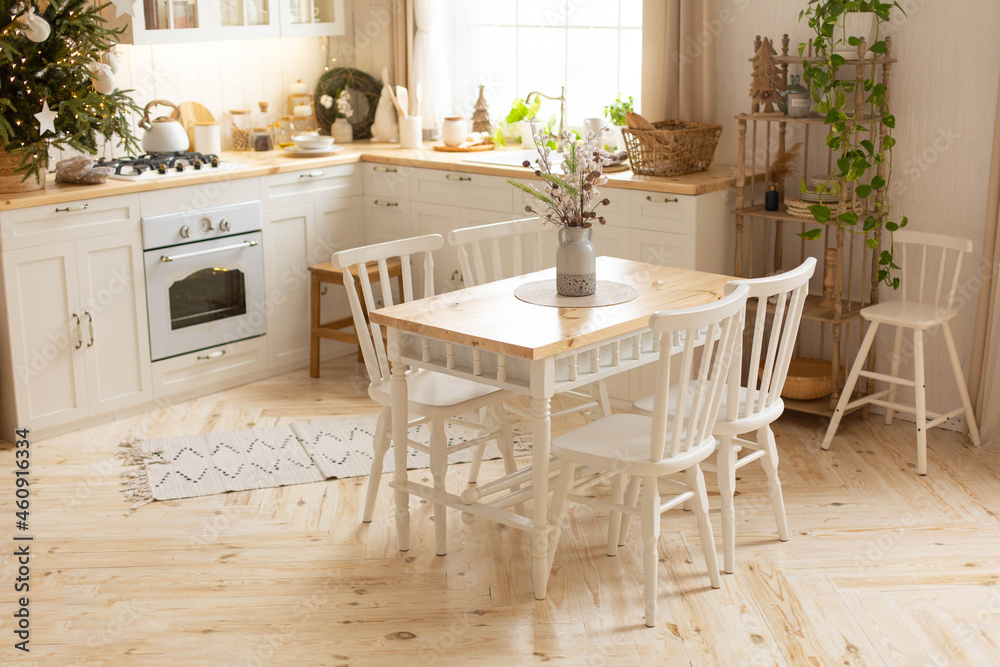 dining room interior in white. dining table with chairs in the middle of the kitchen