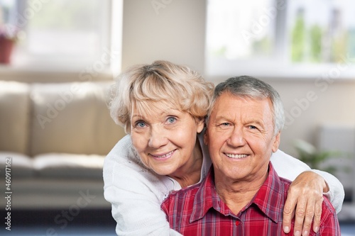 Happy older mature classy couple hugging, thinking of good future.