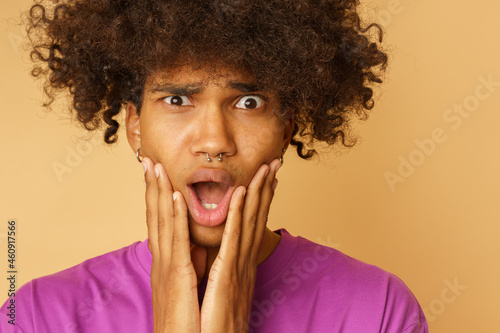 Man with curly hair is amazed about something