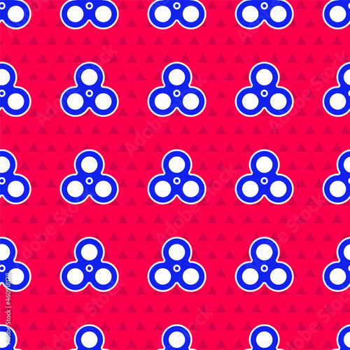 Blue Fidget spinner icon isolated seamless pattern on red background. Stress relieving toy. Trendy hand spinner. Vector