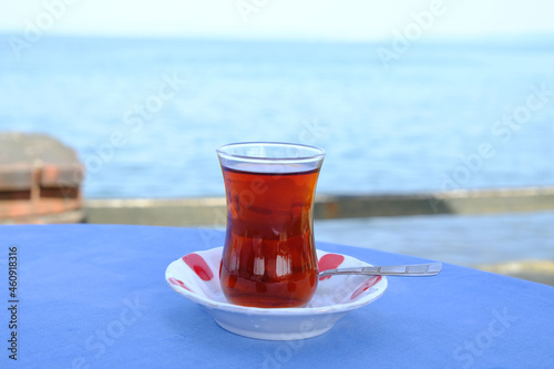 glass of tea on the table with sea view