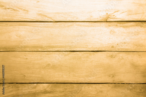 Yellowed wooden plank floor with tree branches and stripes. Yellow background with wooden texture.