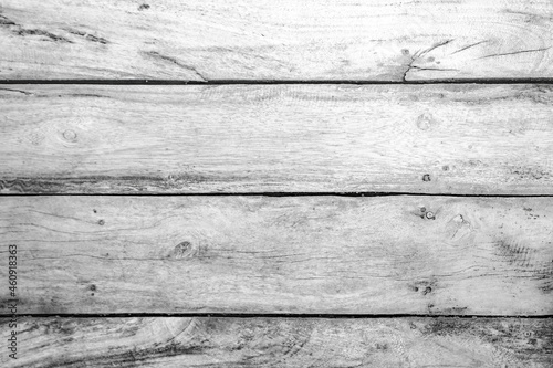 Grey wooden plank floor with tree branches and stripes. Grey background with wooden texture. 