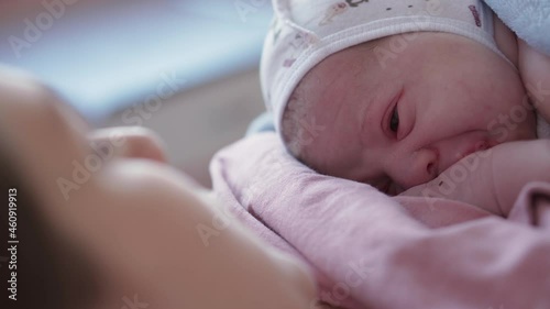 Close Up Portrait Face Newborn Naked Baby On Mom's Chest After Childbirth. Mother Holding Baby Child After Labor In Hospital. Moma Giving Birth To Kid Boy. Parent And Infant First Moments Of Borning