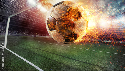 Fototapeta Naklejka Na Ścianę i Meble -  Close up of a fiery soccer ball kicked with power at the stadium scoring a goal