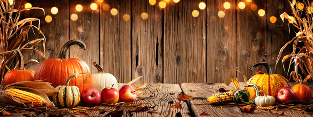 Pumpkins Apples And Corn On Rustic Harvest Table With Bokeh Lights - Harvest And Thanksgiving Background