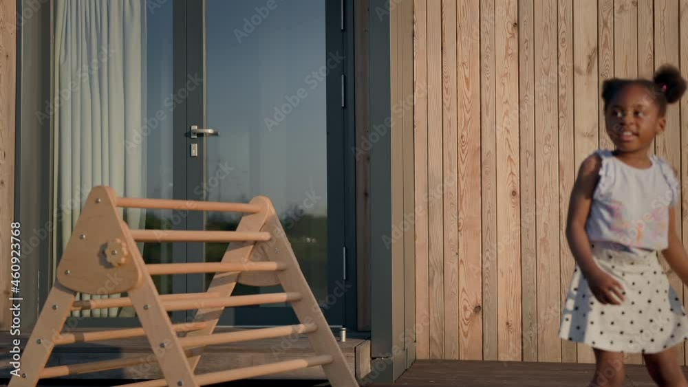 Little Black Girl Sitting On Wooden Slide. Little Black Girl Sitting On Wooden Slide.