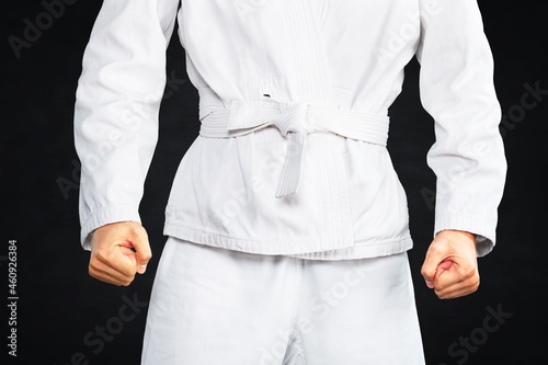 Taekwondo traditional man hand hold a belt on black background for advertising.