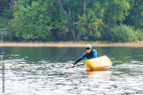 Wallpaper Mural A solo canoeist practices stroke techniques on a rainy fall day as part of a “moving water” paddling course. Shot on the Madawaska River an iconic paddling destination in Eastern Ontario, Canada. Torontodigital.ca