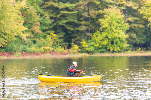 A solo canoeist practices stroke techniques on a rainy fall day as part of a “moving water” paddling course. Shot on the Madawaska River an iconic paddling destination in Eastern Ontario, Canada.