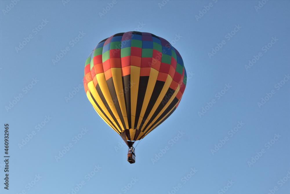 Naklejka premium Colorful hot air balloon in flight with blue skies in the background
