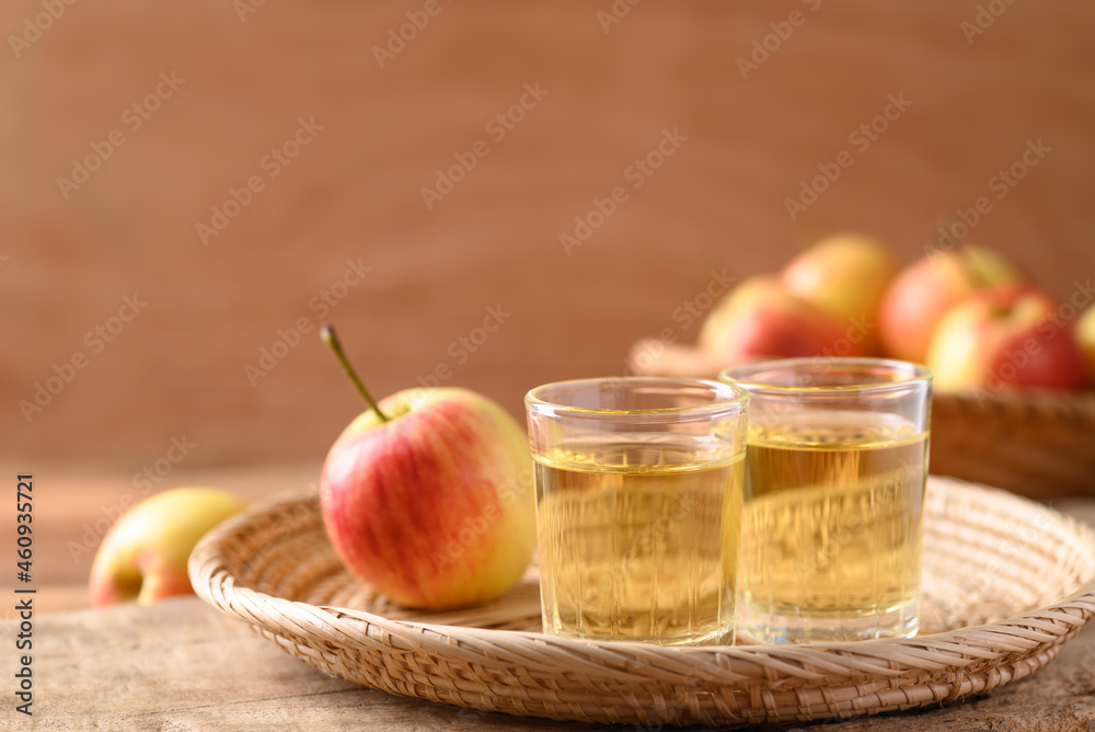 Fresh red apple fruit and juice in a basket on wooden background Fresh red apple fruit and juice in a basket on wooden background