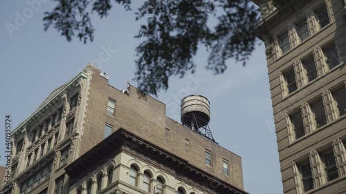 Cropped view of buildings in New York City and rooftop water towers. Horizontal shot.