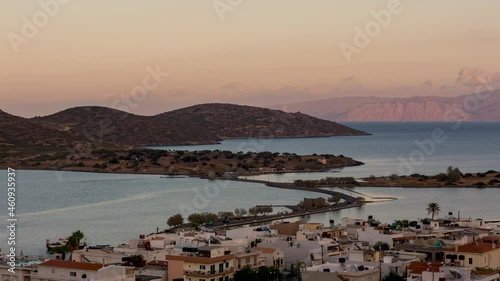 Sunset over a causway and mountains in the Cretan town of Elounda photo