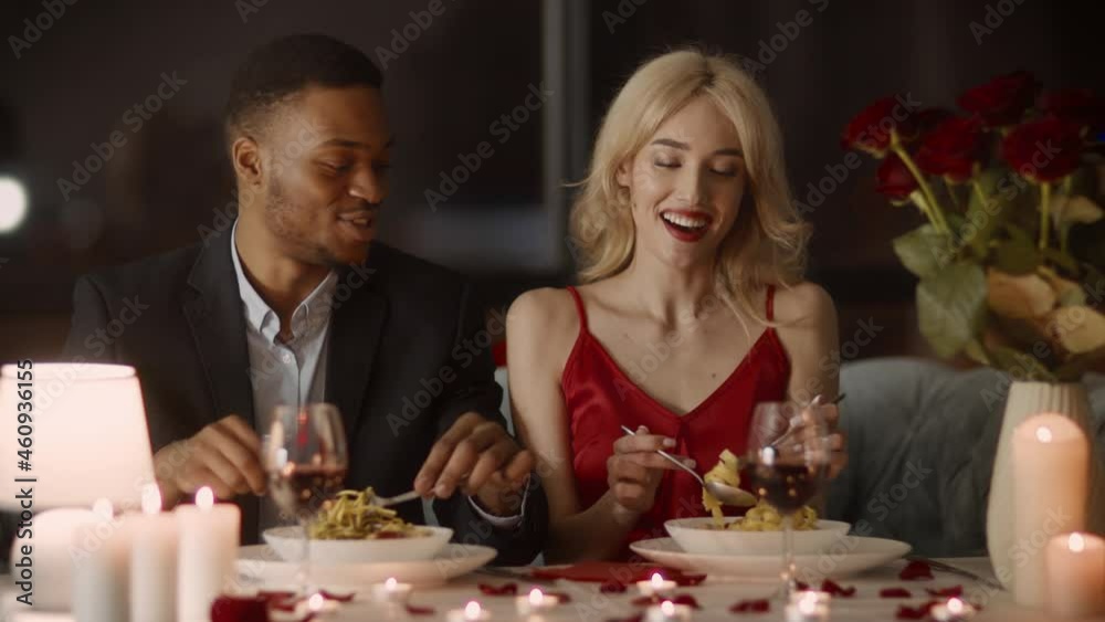 Happy Multiracial Couple Eating Pasta Having Romantic Dinner In Restaurant Happy Multiracial Couple Eating Pasta Having Romantic Dinner In Restaurant