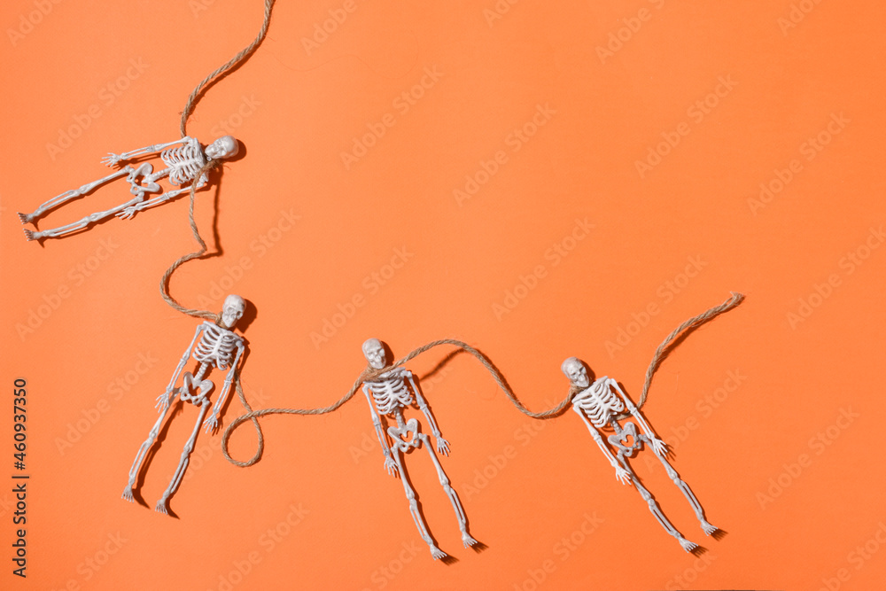 Halloween background with skeletons on an orange background. Halloween background with skeletons on an orange background.