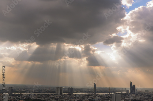 Bangkok, Thailand - Nov 03, 2020 : The sun's rays passing through the clouds and shining on shining on sky over view of bangkok city creates energetic feeling to get ready for the day waiting ahead. C