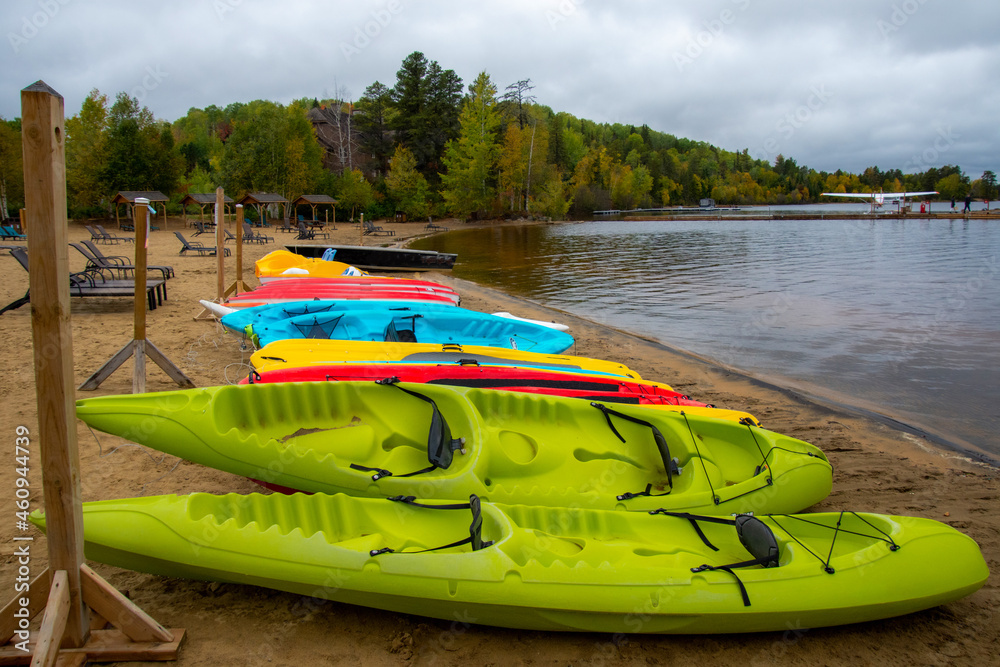 Fototapeta premium Canoe and kayak on the beach of a wild lake in the Canadian forest in Quebec