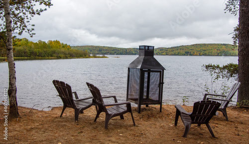 Resting place with fireplace on the edge of a wild lake in Quebec, Canada