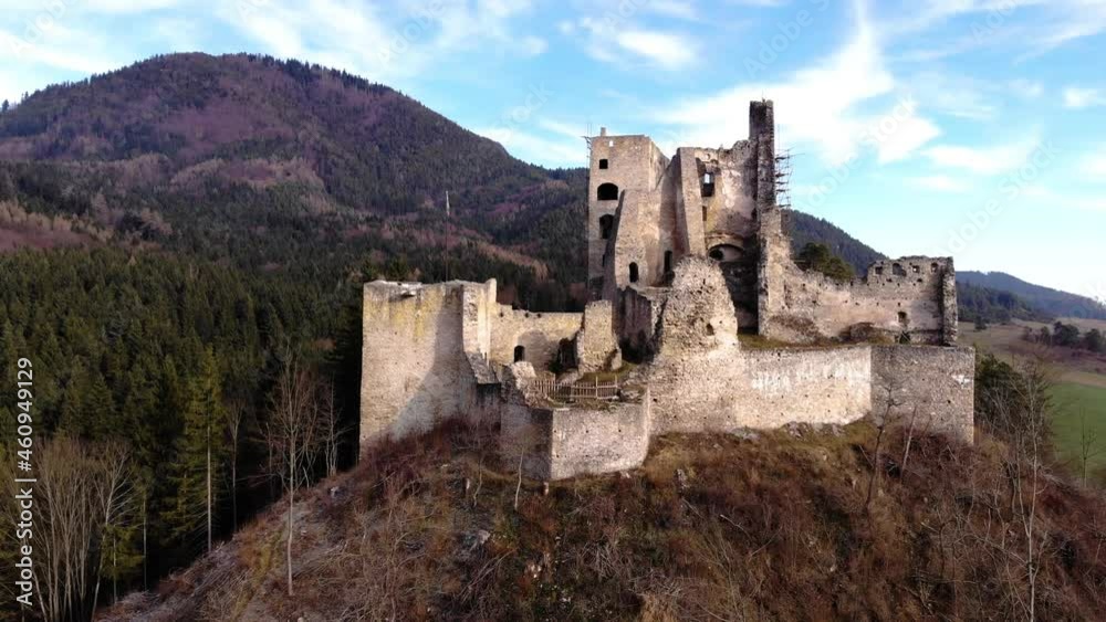 Ruins of a medieval castle from the front of a drone in the middle of the mountains of a Slovakian landscape. Ruins of a medieval castle from the front of a drone in the middle of the mountains of a Slovakian landscape.